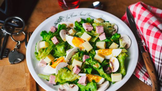 Classic Parisian restaurant mixed salad with ham, mushroom, cheese and egg
