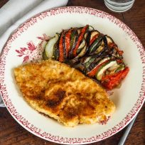 breaded escalope served with vegetable tian