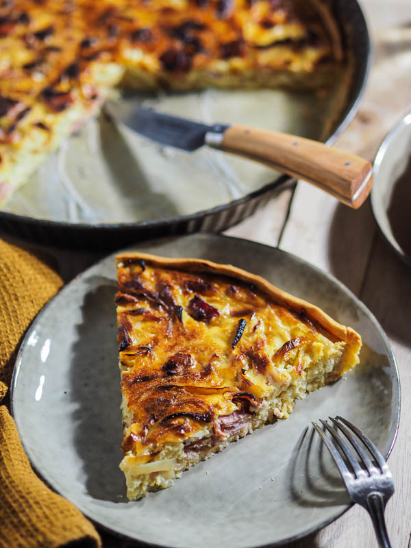 A slice of quiche and onion and carmelized bacon